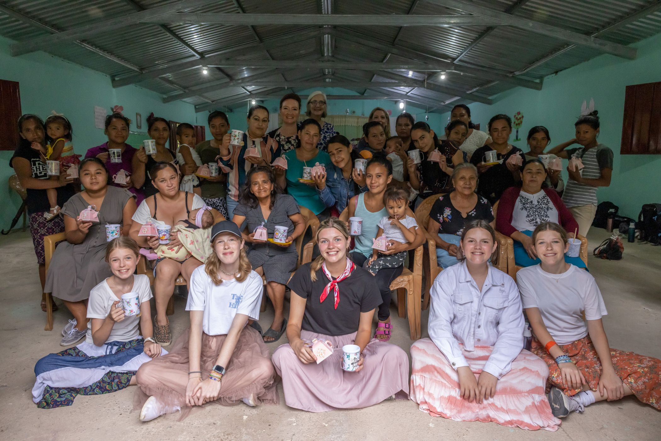 A group of people sitting together smiling