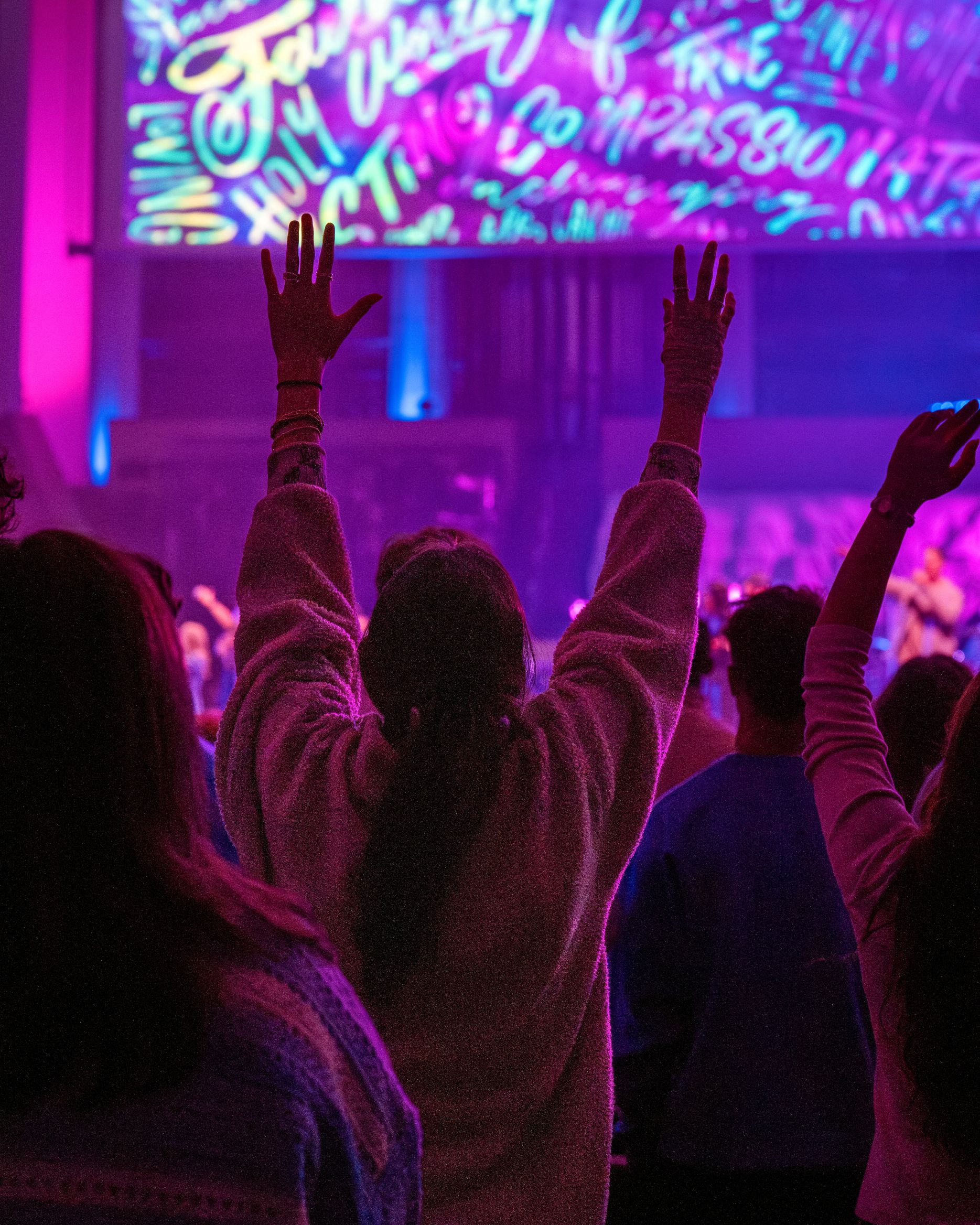 Woman with arms raised in worship
